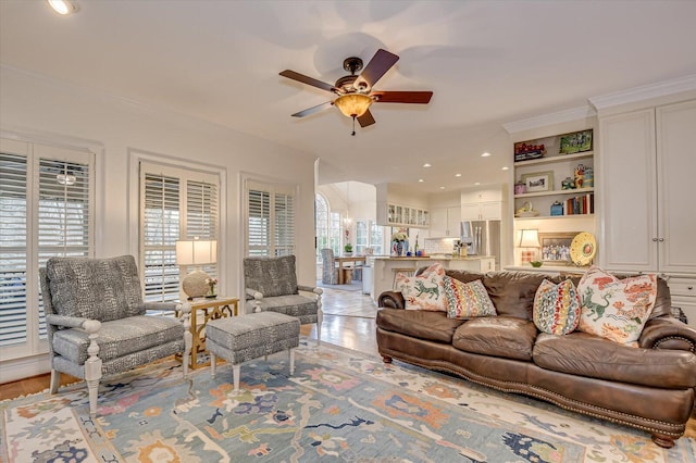 living area featuring ceiling fan, ornamental molding, and recessed lighting