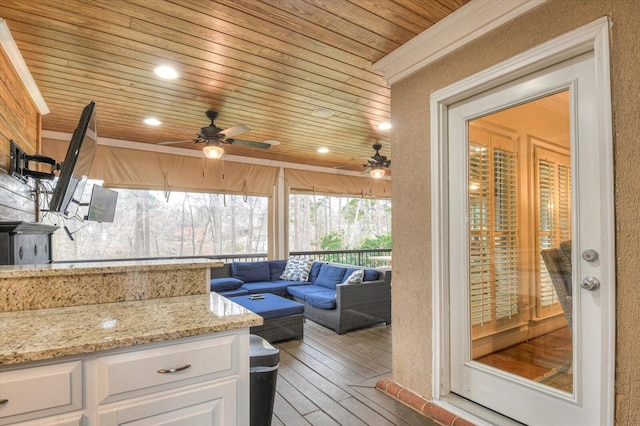 interior space with wooden ceiling and ceiling fan