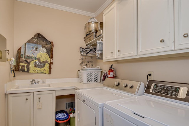 washroom with washing machine and dryer, a sink, visible vents, ornamental molding, and cabinet space