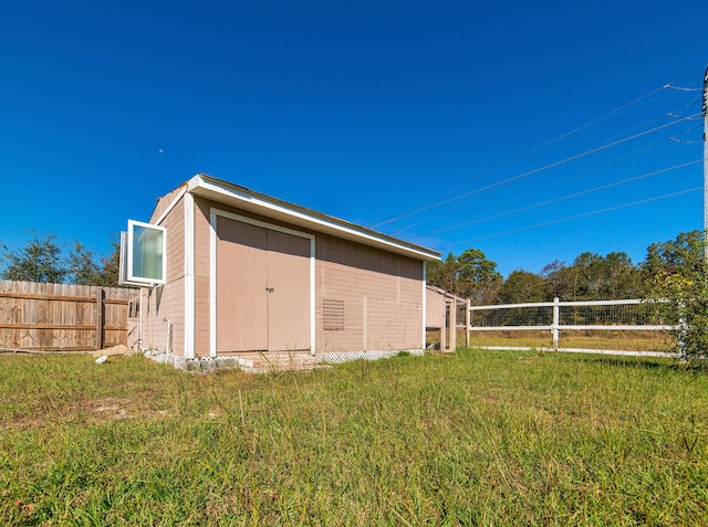 view of outbuilding featuring a lawn