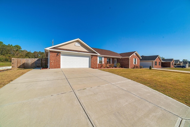 ranch-style house featuring a front yard and a garage