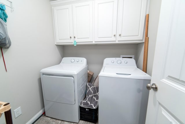 laundry room with cabinets and separate washer and dryer