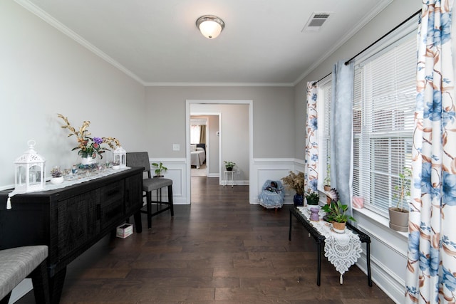 sitting room with crown molding and dark wood-type flooring