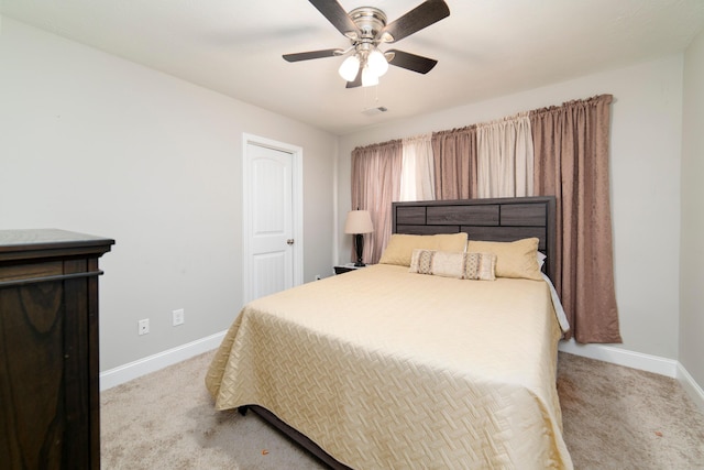 bedroom with ceiling fan and light carpet