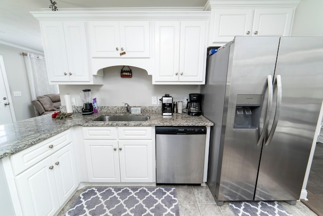 kitchen featuring stainless steel appliances, white cabinetry, and sink