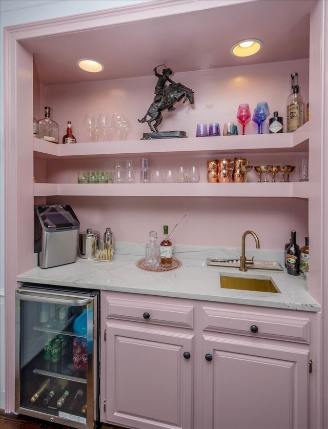 bar with beverage cooler, wet bar, a sink, and recessed lighting