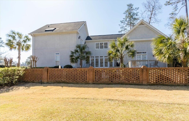 rear view of house with stucco siding