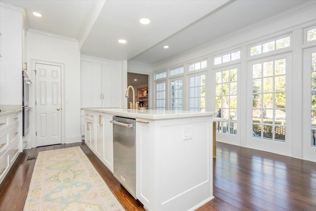 kitchen featuring appliances with stainless steel finishes, dark wood-style flooring, light countertops, and crown molding