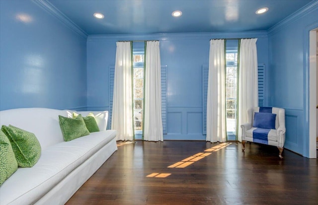 living area with ornamental molding, wood finished floors, and recessed lighting