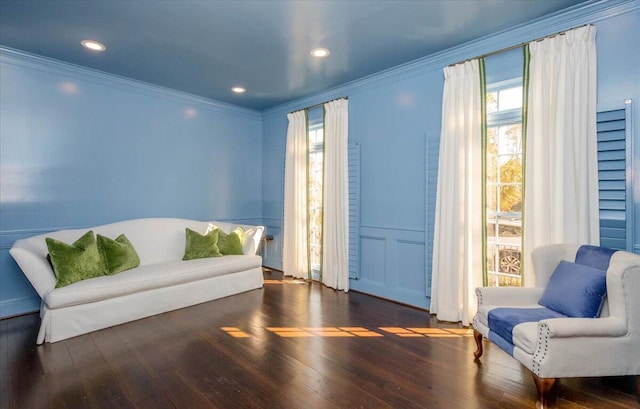 living area with ornamental molding, wood finished floors, and recessed lighting