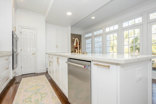 kitchen with white cabinetry, appliances with stainless steel finishes, dark wood-style flooring, and ornamental molding