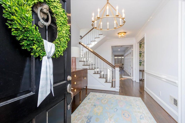 entryway with stairs, ornamental molding, and wood finished floors