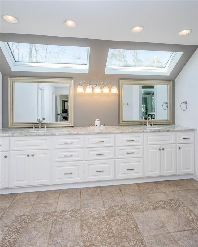 bathroom featuring recessed lighting, a sink, and double vanity