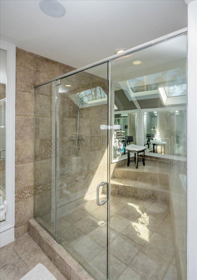 full bathroom with a shower stall and tile patterned floors