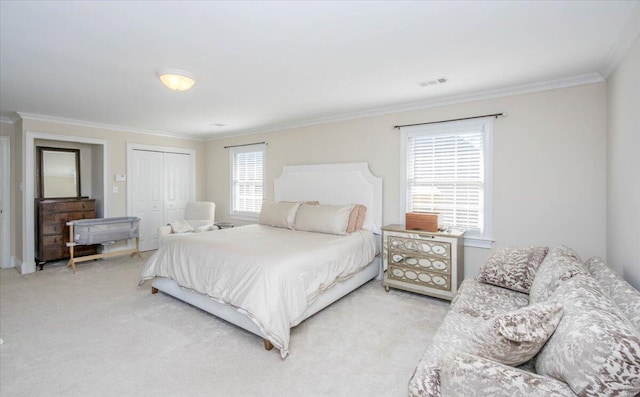 bedroom featuring a closet, light carpet, crown molding, and visible vents