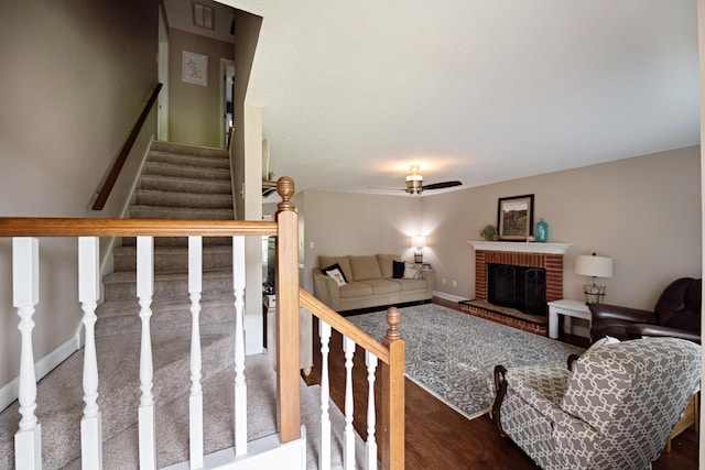 3943 Carson Cutoff, Martinez, GA 30907 - living room with stairway, wood finished floors, ceiling fan, and a brick fireplace