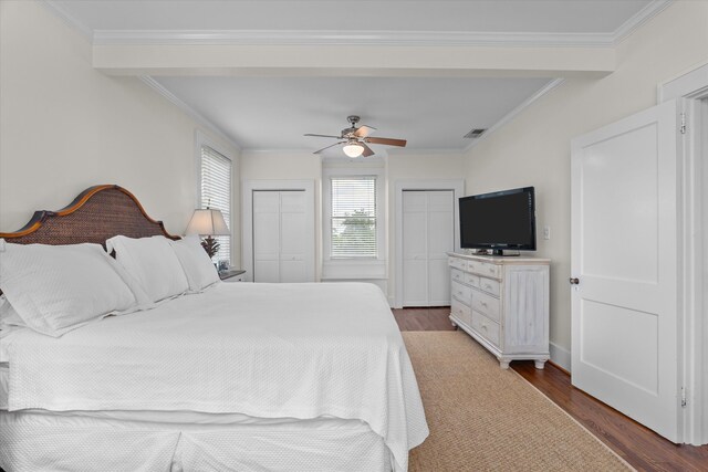 2442 Mcdowell St, Augusta, GA 30904 - bedroom featuring crown molding, two closets, wood finished floors, and visible vents