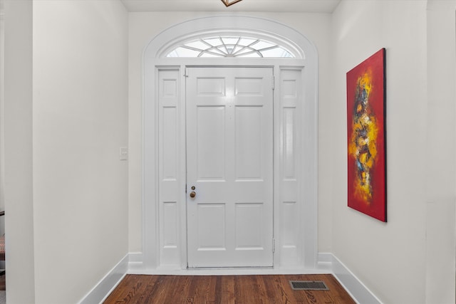 entrance foyer featuring visible vents, baseboards, and dark wood-type flooring