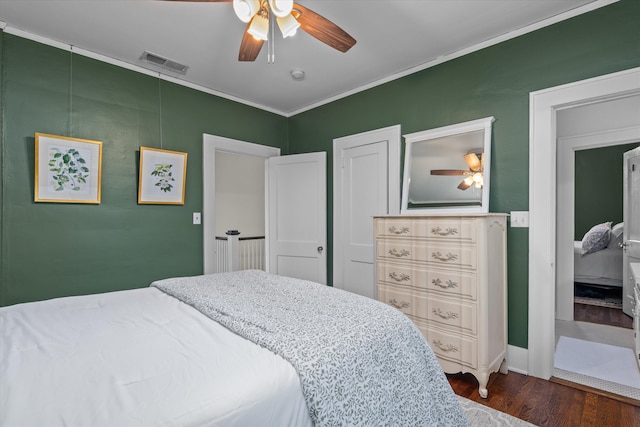 bedroom with crown molding, a ceiling fan, visible vents, and wood finished floors