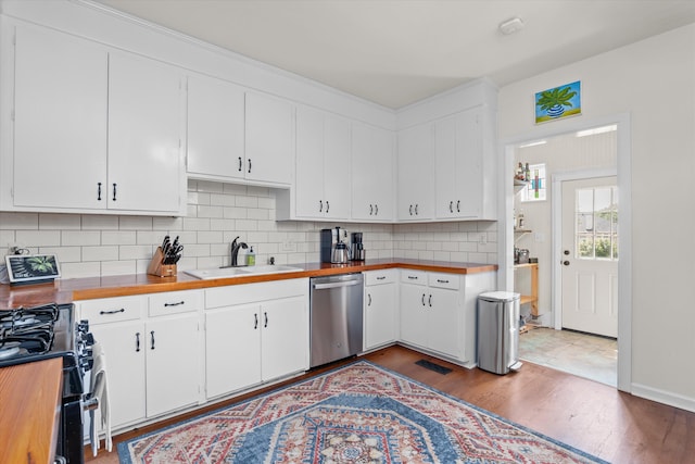 2442 Mcdowell St, Augusta, GA 30904 - kitchen with stainless steel dishwasher, wooden counters, a sink, and wood finished floors