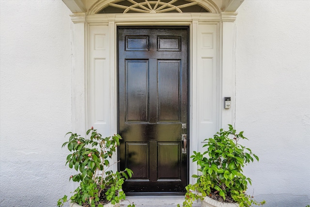 doorway to property with stucco siding