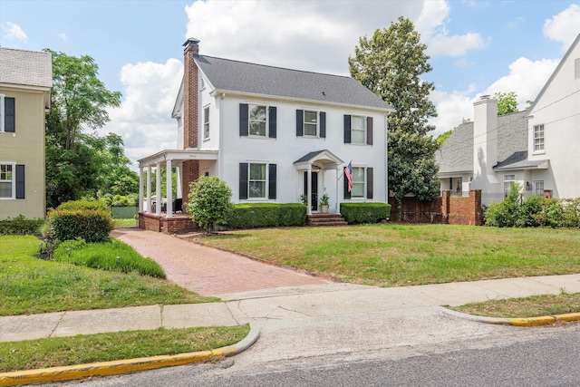 2442 Mcdowell St, Augusta, GA 30904 - colonial home with a chimney, a shingled roof, a front yard, and stucco siding