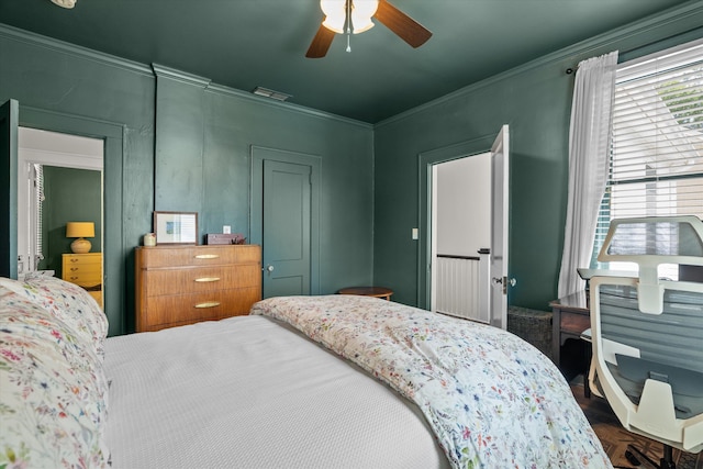 bedroom with visible vents, ornamental molding, and ceiling fan