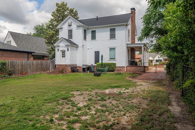 2442 Mcdowell St, Augusta, GA 30904 - rear view of house featuring fence, a chimney, and a yard