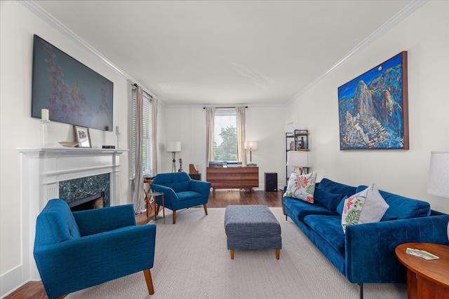 living room with crown molding, wood finished floors, and a fireplace