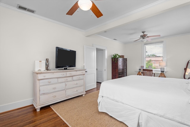 bedroom with visible vents, ornamental molding, baseboards, and wood finished floors