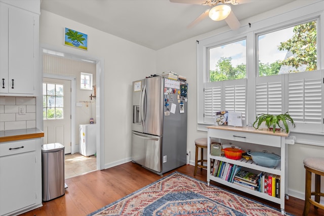 2442 Mcdowell St, Augusta, GA 30904 - kitchen with light wood-style flooring, ceiling fan, white cabinetry, and stainless steel fridge with ice dispenser