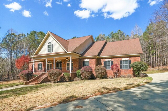 view of front facade with a front lawn and a porch