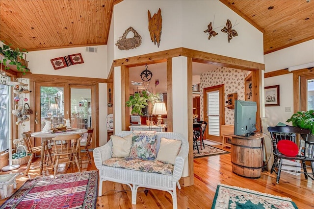 living room featuring high vaulted ceiling, wooden ceiling, and light wood-type flooring