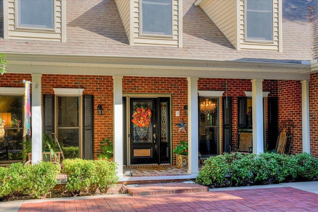 view of exterior entry featuring a porch