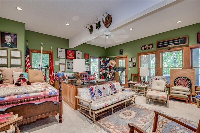 bedroom featuring multiple windows, ceiling fan, beamed ceiling, and light carpet