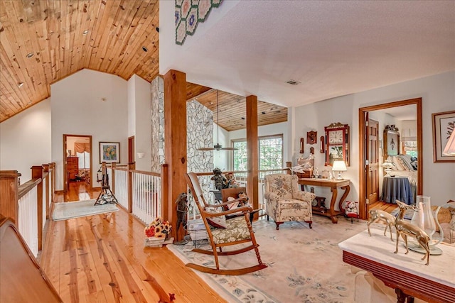 sitting room with hardwood / wood-style floors, wooden ceiling, and lofted ceiling