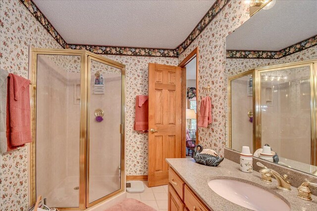 bathroom featuring vanity, a textured ceiling, tile patterned floors, and a shower with door