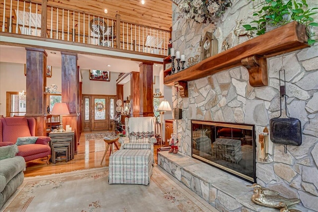 living room with a fireplace, a high ceiling, concrete flooring, and french doors