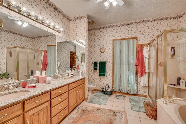 full bathroom featuring tile patterned floors, ceiling fan, separate shower and tub, and a textured ceiling