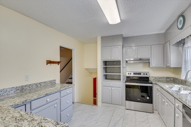 kitchen with under cabinet range hood, marble finish floor, stainless steel appliances, and a sink