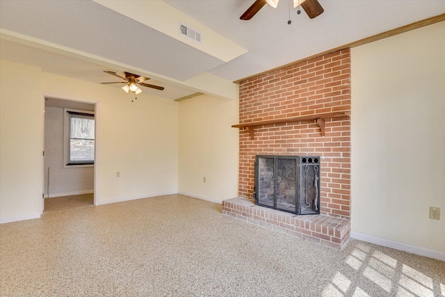 unfurnished living room with visible vents, beam ceiling, a ceiling fan, a fireplace, and baseboards