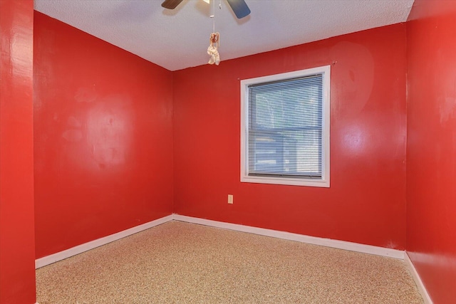 unfurnished room with a textured ceiling, baseboards, and ceiling fan