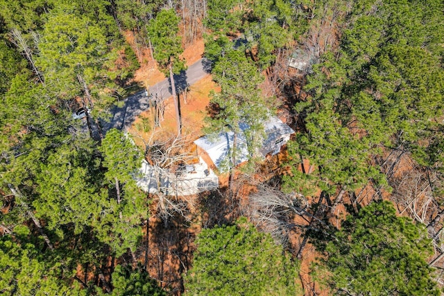 drone / aerial view with a wooded view