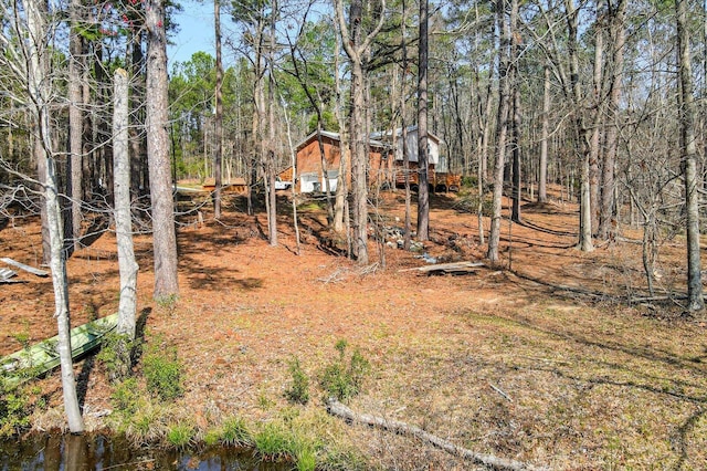 view of yard with a forest view