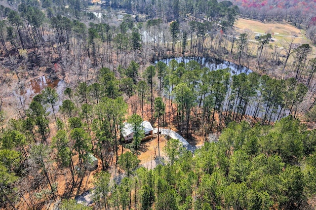 birds eye view of property with a view of trees and a water view