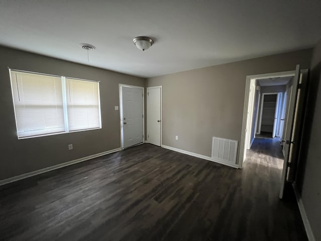 spare room with dark wood-type flooring