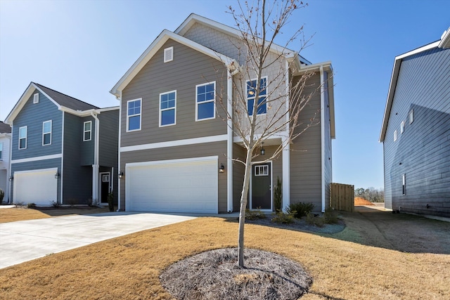 view of front of home with a front lawn, concrete driveway, and an attached garage