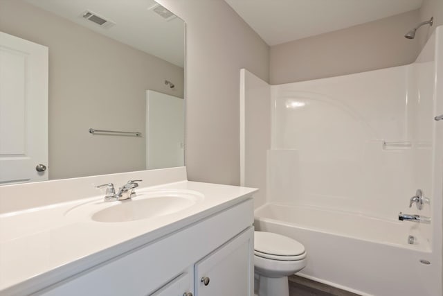 full bathroom featuring visible vents, vanity, toilet, and tub / shower combination