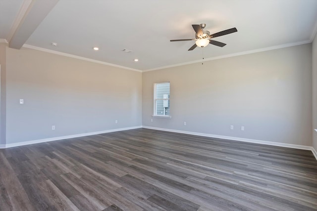 empty room with dark wood-style floors, ornamental molding, and baseboards