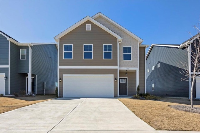 view of front of property with a garage and concrete driveway